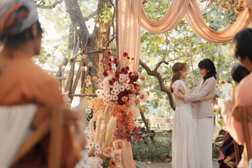 Couple, bride and groom walk hand in hand and guests applaud during the wedding ceremony.